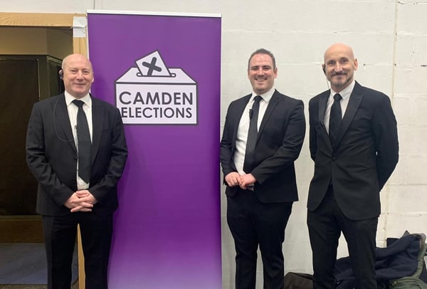 Off to Work's Head of Security, Jason Henderson, standing between two security personnel at the Camden Elections in December 2019